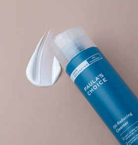 Paula's Choice cleanser held in hand to show 8oz scale and convenient everyday size