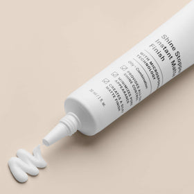 Paula's Choice primer texture close-up on fingertip, highlights silky powder-like finish