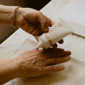 PAUME applying serum to hands demonstrating improved softness benefit