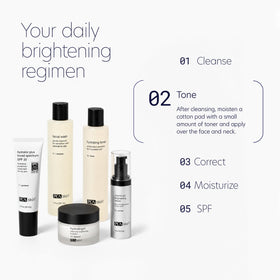 PCA SKIN hydrating toner bottle next to hand for size comparison and travel convenience