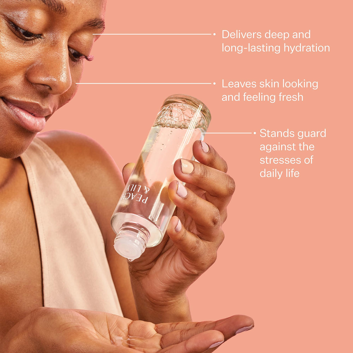Peach & Lily Wild Dew held in hand to show size and easy-pour usability
