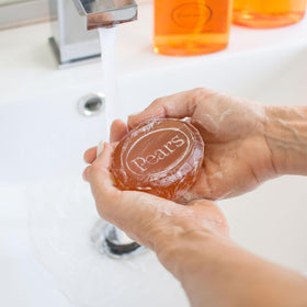 Pears amber lather foaming in hand to show mild cleansing and moisturizing effect
