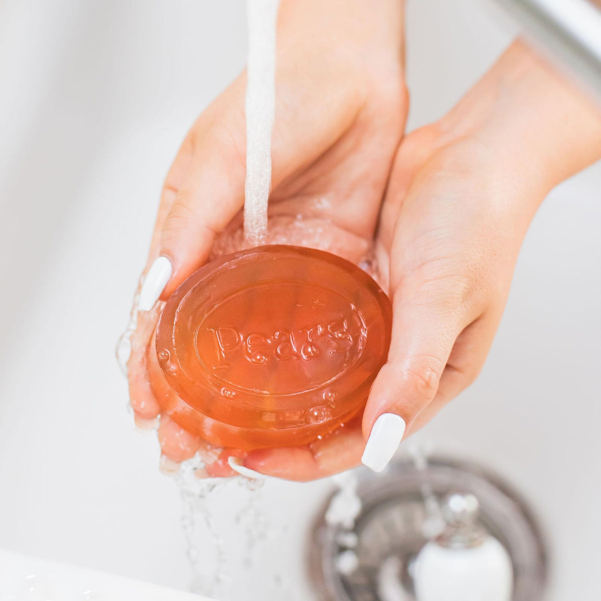 Pears soap bar in hand illustrating true size and ease of use for everyday cleansing