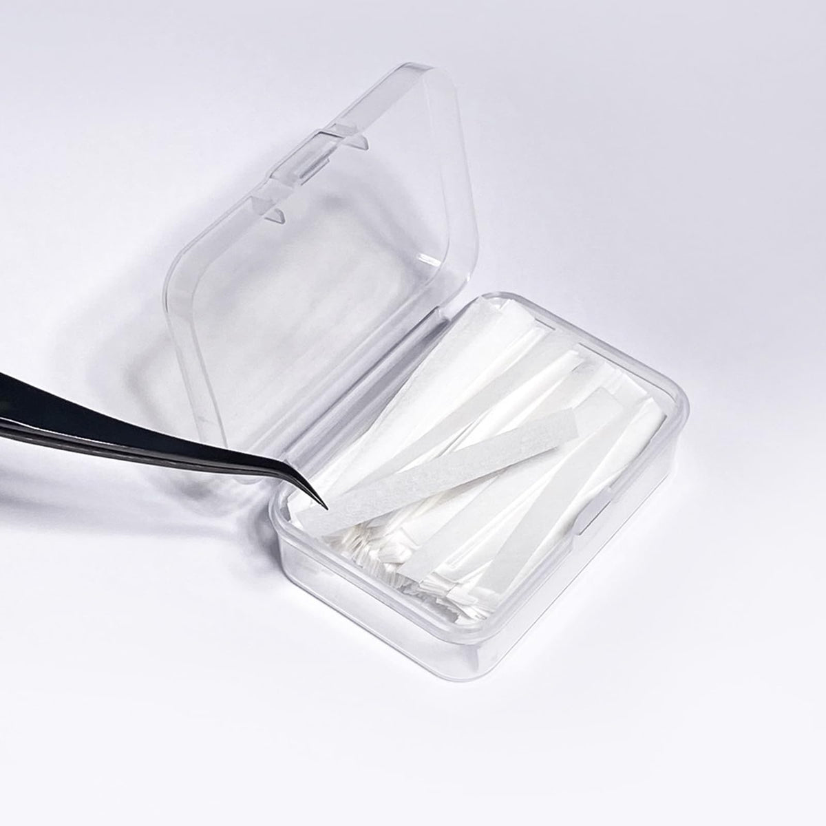 PERMANIA strip positioned on a silicone pad to secure lashes during perm