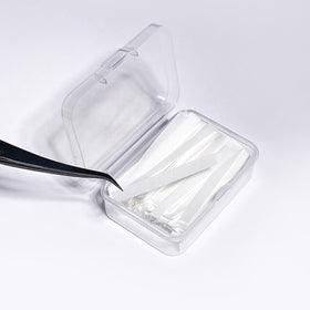 PERMANIA strip positioned on a silicone pad to secure lashes during perm