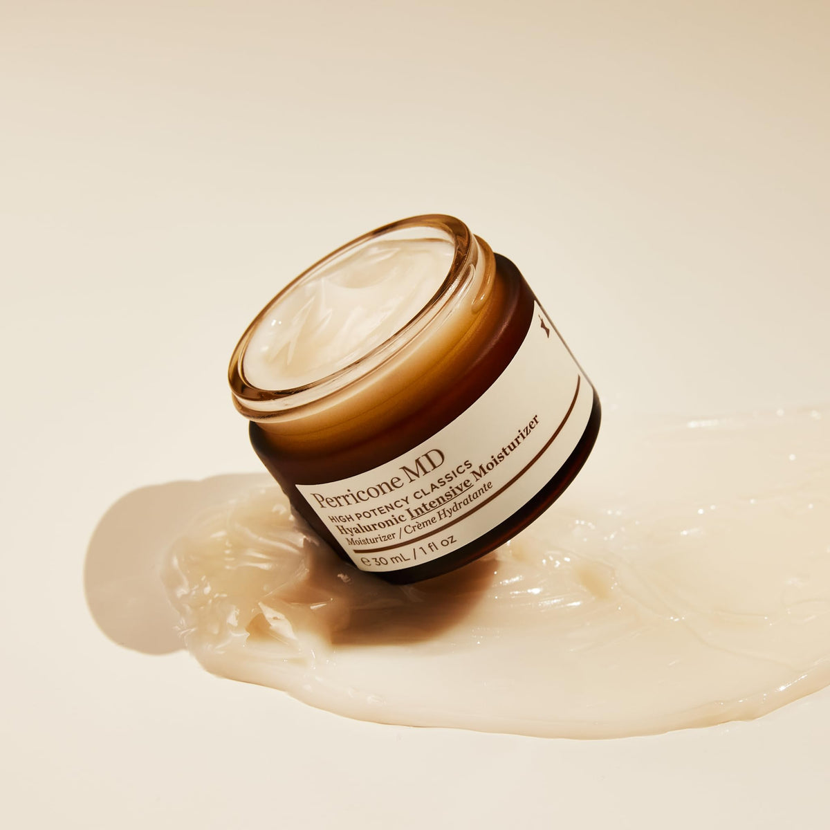 Perricone MD shown in hand to illustrate compact 1 fl oz size and travel-friendly use
