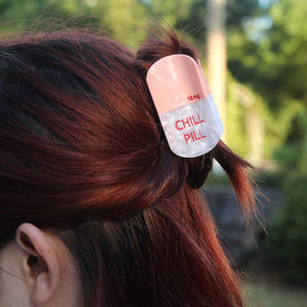 PERSONFUN clip beside a hand to show scale and easy one-hand application benefit