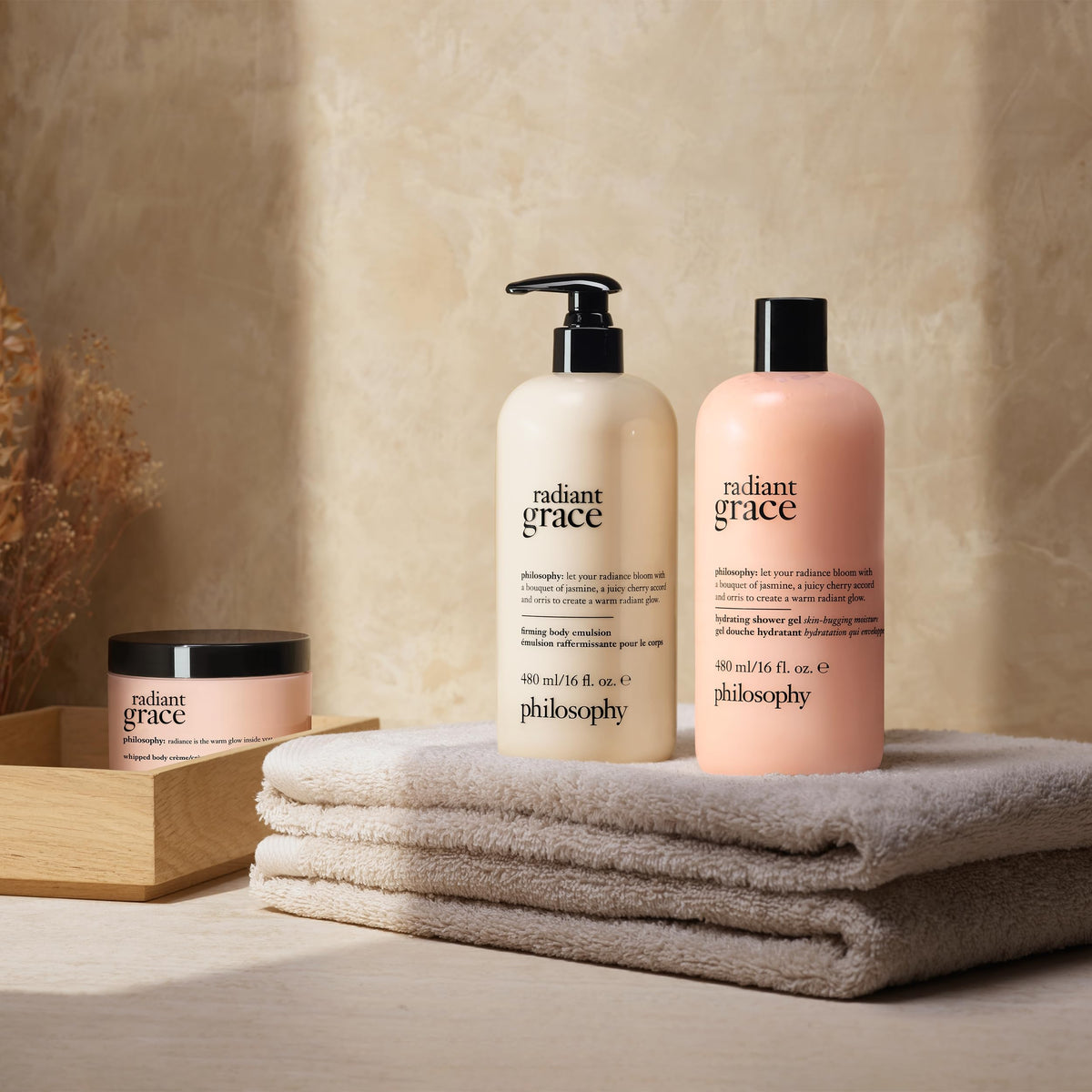 philosophy bottle beside bubble-filled bath suggesting relaxing soak