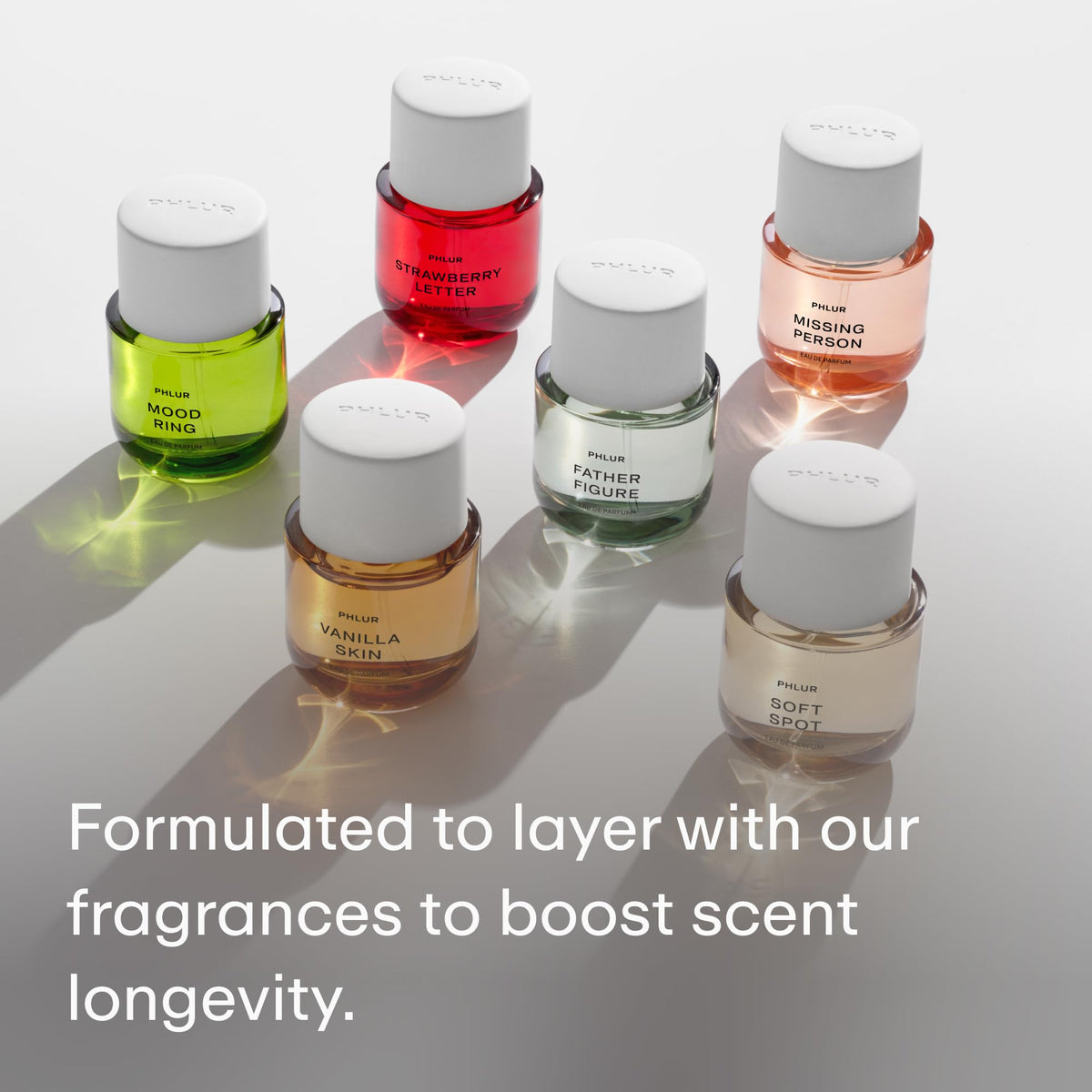 PHLUR 4 fl oz bottle in hand demonstrating compact size and travel-friendly benefit
