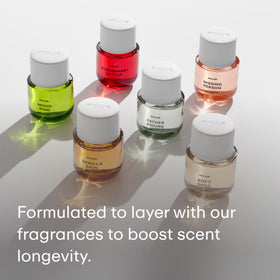 PHLUR 4 fl oz bottle in hand demonstrating compact size and travel-friendly benefit
