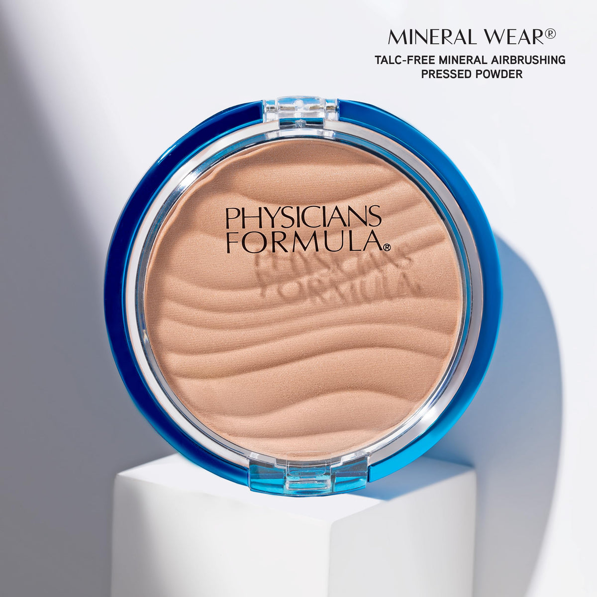 Physicians Formula powder swatched on hand to show translucent coverage and blendability benefit