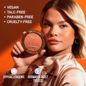 Physicians Formula bronzer next to coin for size and scale indicating portable compact