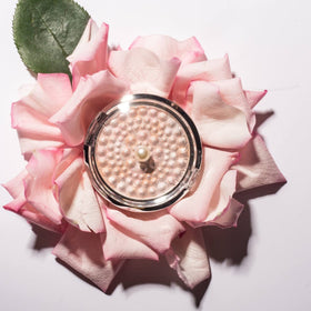 Physicians Formula compact in a makeup bag for travel-ready glow and easy application benefit