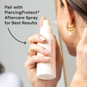 PiercingProtect swabs beside aftercare spray in a tidy bathroom setup