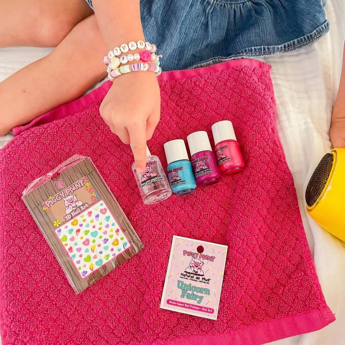 Three Piggy Paint bottles next to a coin size comparison for compact, travel-friendly size