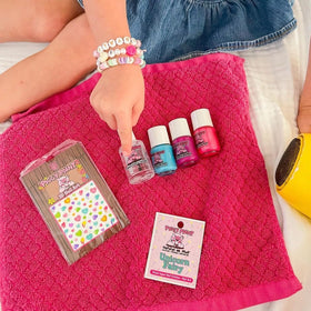Three Piggy Paint bottles next to a coin size comparison for compact, travel-friendly size