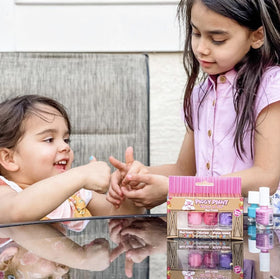 Kid playing in bedroom wearing Piggy Paint manicure for a cheerful look