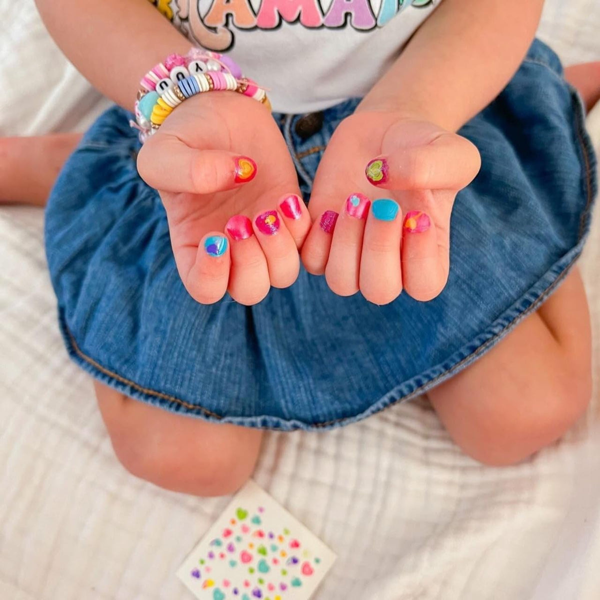 Piggy Paint applying sticker to nail demonstrating easy child-safe use