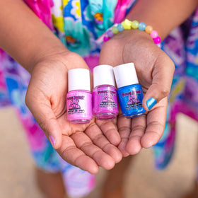 Piggy Paint next to coin showing compact bottle size and travel convenience