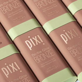 Pixi size comparison next to coin showing compact travel-friendly benefit