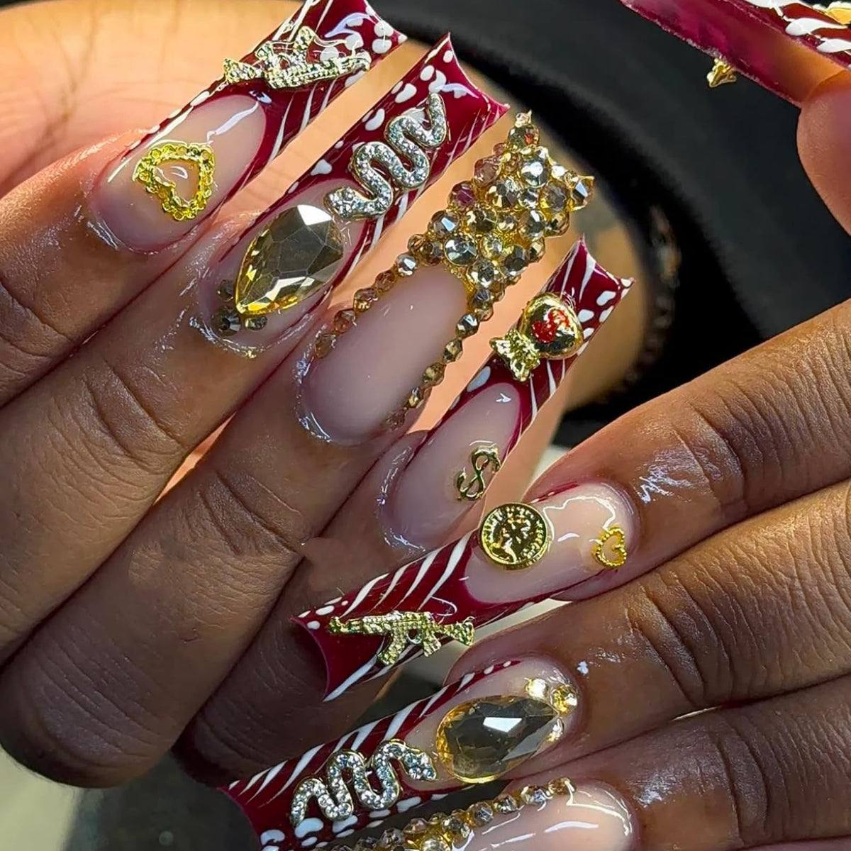 Pizadix cherries and dollar sign charms on finished nails for glam look