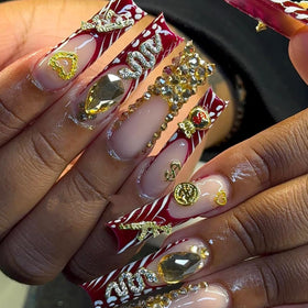 Pizadix cherries and dollar sign charms on finished nails for glam look
