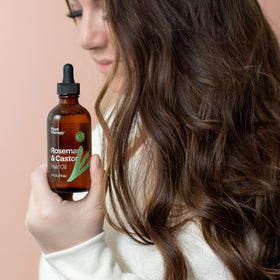 Applying Plant Therapy oil to scalp during massage to support healthy-feeling scalp