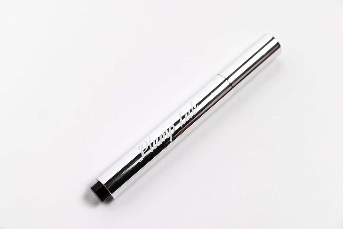 Plump Lab gloss worn by model adds visible gloss and fuller-looking lips benefit