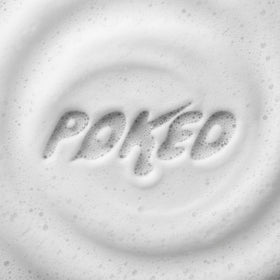 Poked hand using soap on fresh tattoo showing gentle application benefit