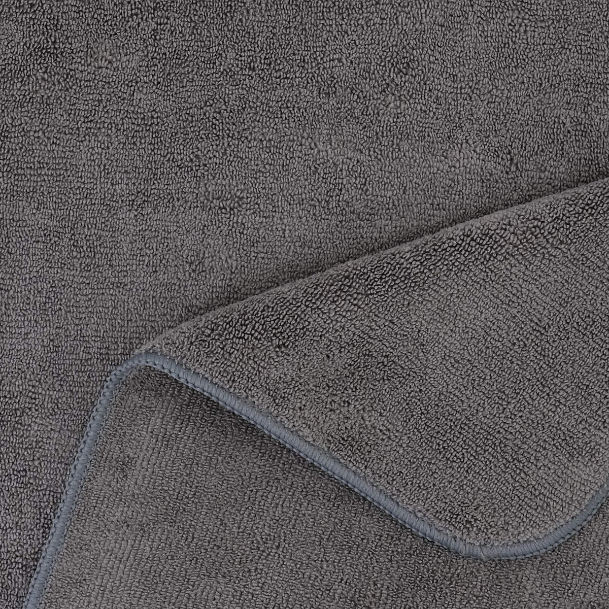 POLYTE towel next to a hand for scale showing large 20 x 40 inch coverage advantage