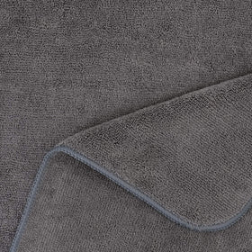 POLYTE towel next to a hand for scale showing large 20 x 40 inch coverage advantage