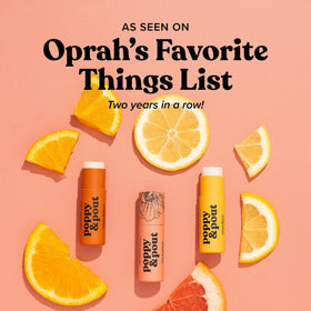 Poppy & Pout ingredients flatlay showing coconut oil, beeswax, vitamin E benefits