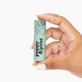 Poppy & Pout balm in outdoor setting showing convenient on-the-go refreshment benefit
