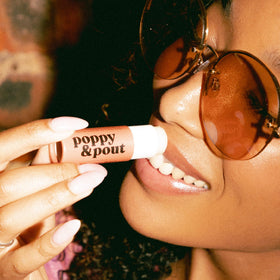 Poppy & Pout lifestyle outdoor use demonstrating protective lip care on the go