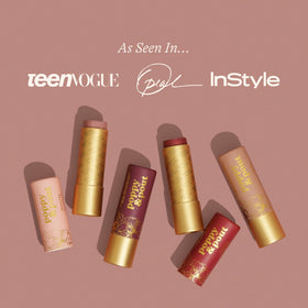 Poppy & Pout Roxie applied on lips for buildable brick tint and soft finish