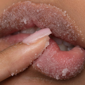 Poppy & Pout scrub being applied to lips demonstrating smooth exfoliation