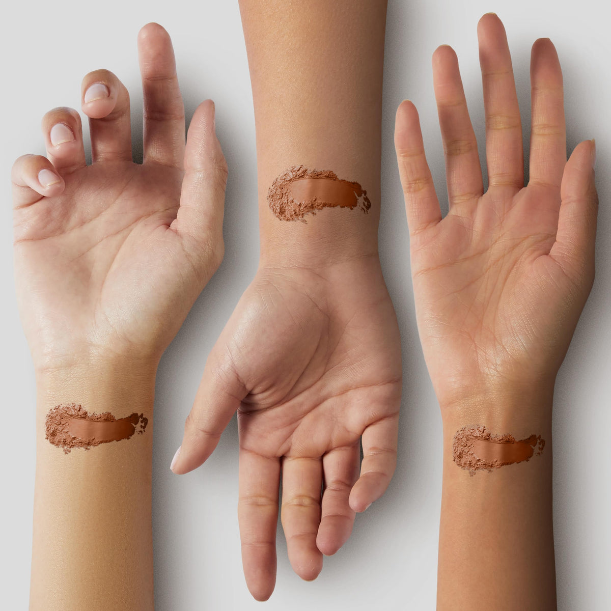 Fluffy brush picking up Pure Minerals bronzer for even application benefit