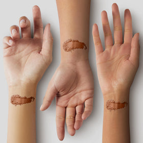 Fluffy brush picking up Pure Minerals bronzer for even application benefit