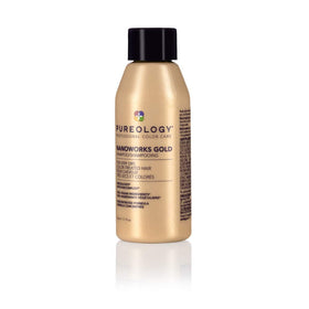 Pureology Nanoworks Gold on bathroom shelf with towels, lifestyle scene suggests salon-level care
