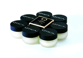QTICA cuticle balm applied to fingernail cuticle in lifestyle scene soothes and protects
