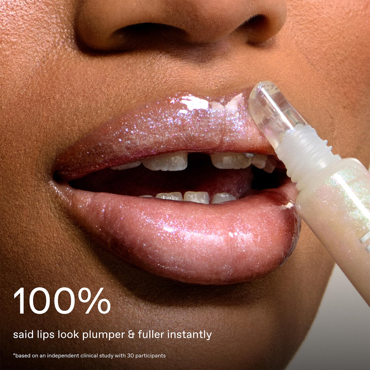 r.e.m. beauty gloss held in hand to show true size and portable design