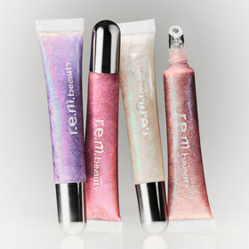r.e.m. beauty gloss on lips in lifestyle shot showing plumping shine