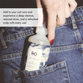 R+Co bottle styled on bathroom shelf conveying clean, shiny hair results