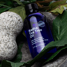 Radha Beauty tea tree oil drop on palm highlighting clear texture and easy dilution