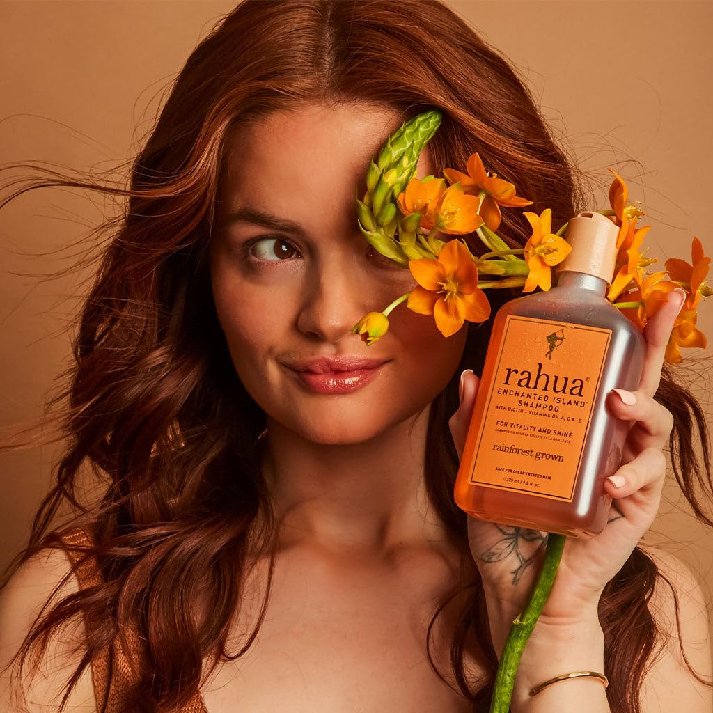 Rahua bottle beside guava and coconut illustrating natural fragrance and freshness