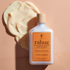 Rahua bottle beside guava and coconut highlighting the tropical scent