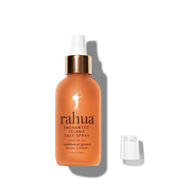 Model using Rahua on the beach demonstrating effortless island-scented styling benefit
