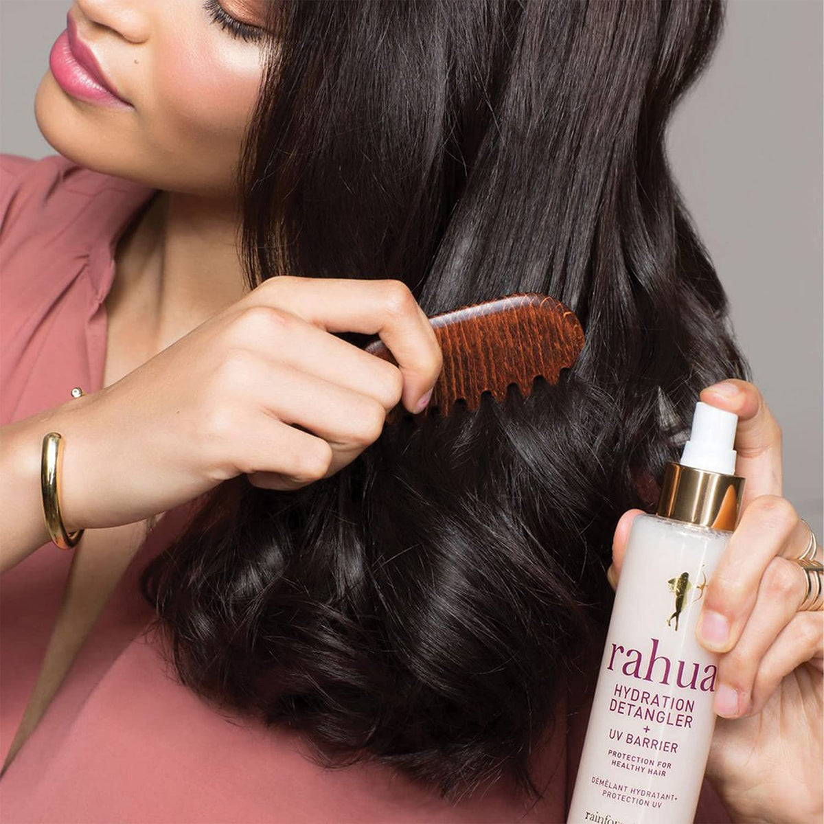 Rahua lifestyle shot at beach illustrating UV barrier and frizz control