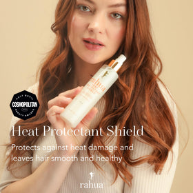 Rahua bottle held in hand to show 6.5 fl oz size and travel-friendly styling benefit
