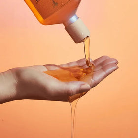 Rahua shampoo in shower lifestyle scene indicating daily use and refreshed hair
